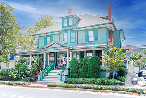 Two story house with a teal exterior