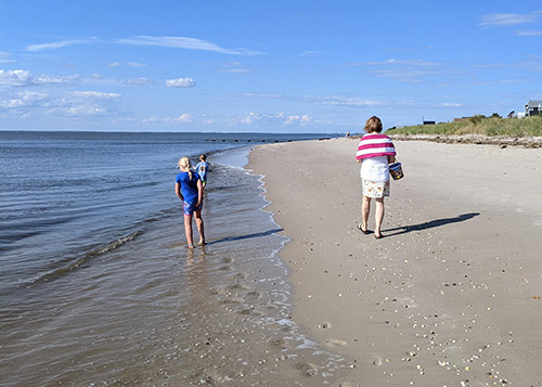 A woman and two children walking along the Delaware Bay beaches