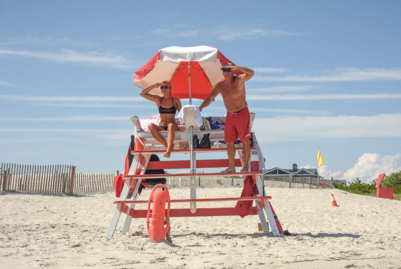 Lifeguards on their stand looking out toward the water