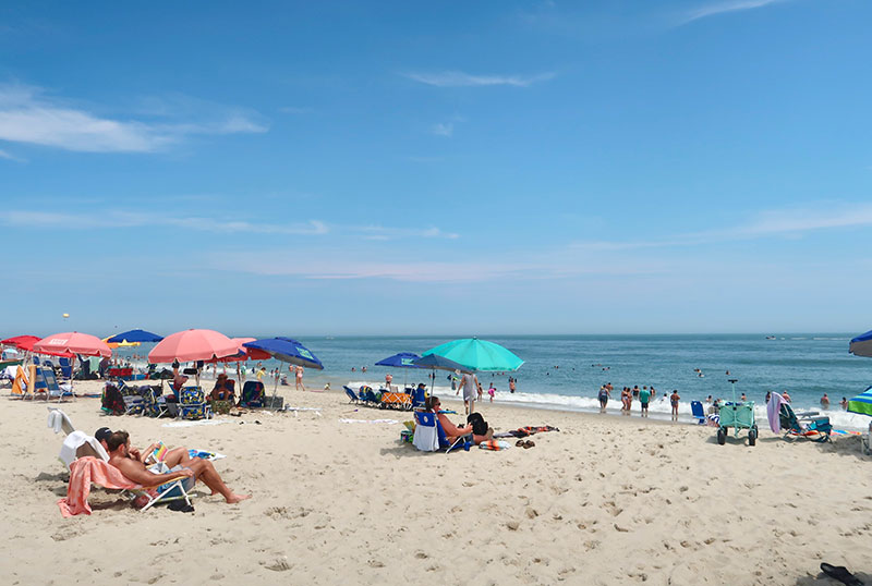 People on the beach under umbrellas