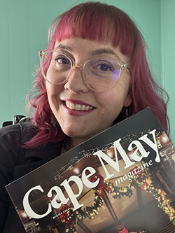 Jess Formento holding up a copy of Cape May Magazine