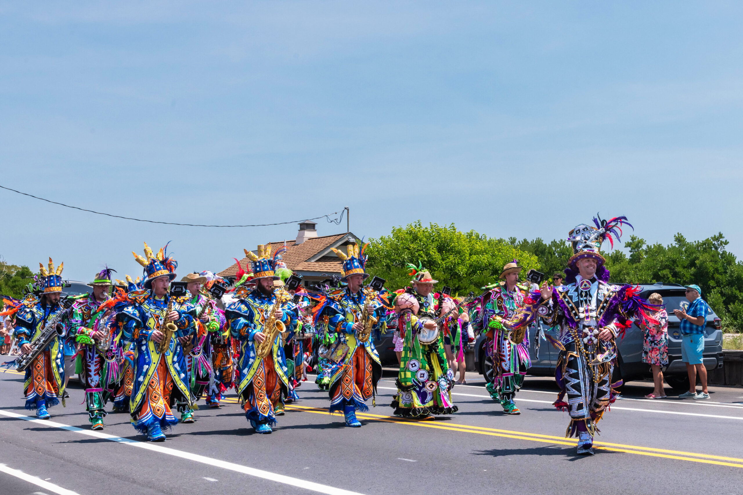 A group of mummers playing instruments in the Cape May 4th of July parade on a sunny day.
