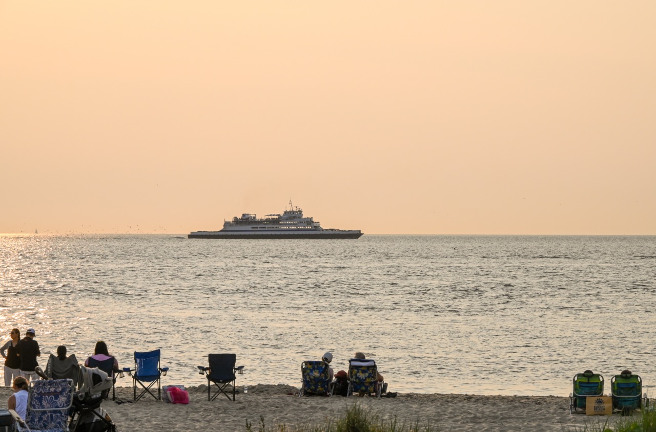 People watching the sunset and the Faeey as they're On Their Way Back