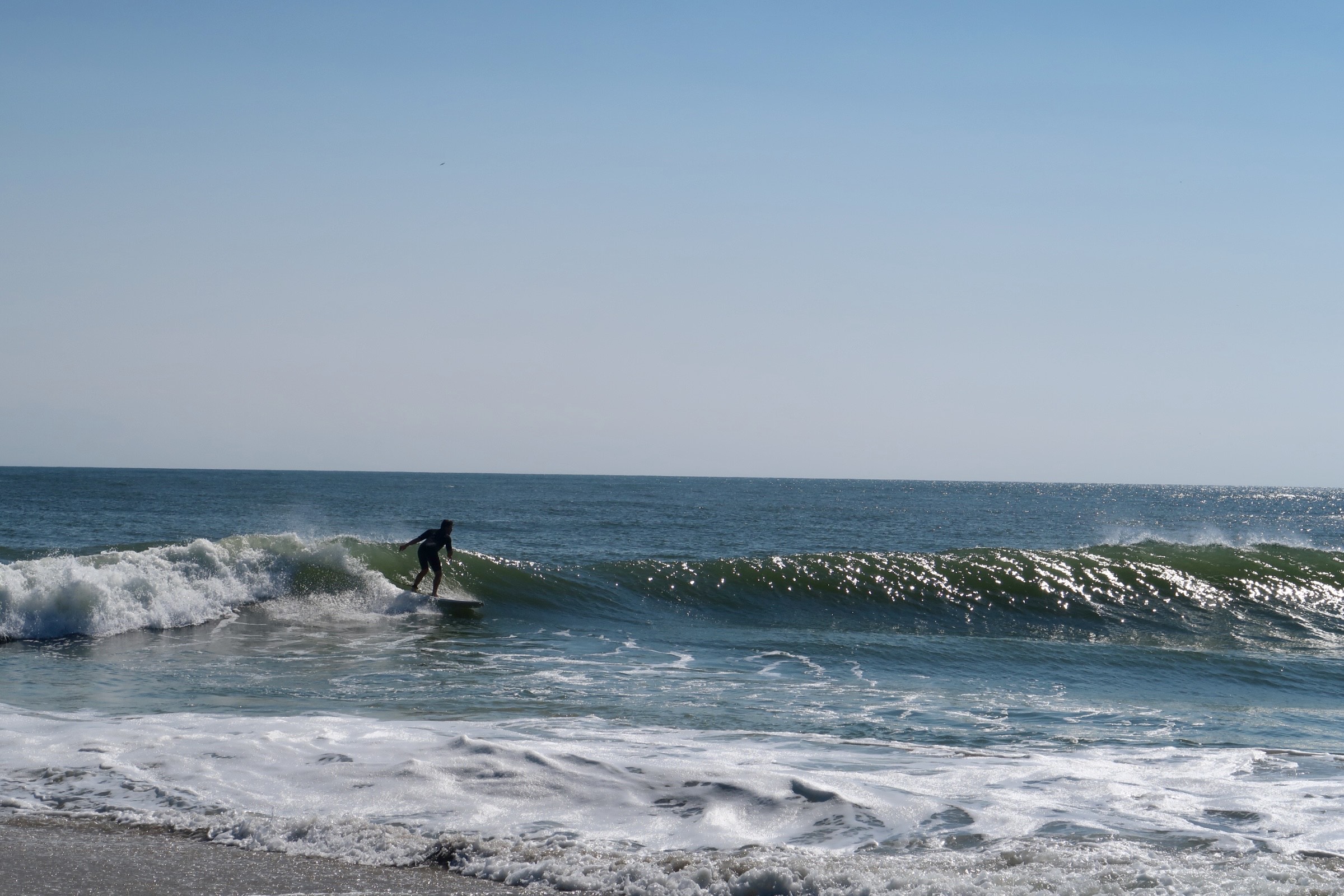 Surfer at Queen Street beach catching a wave