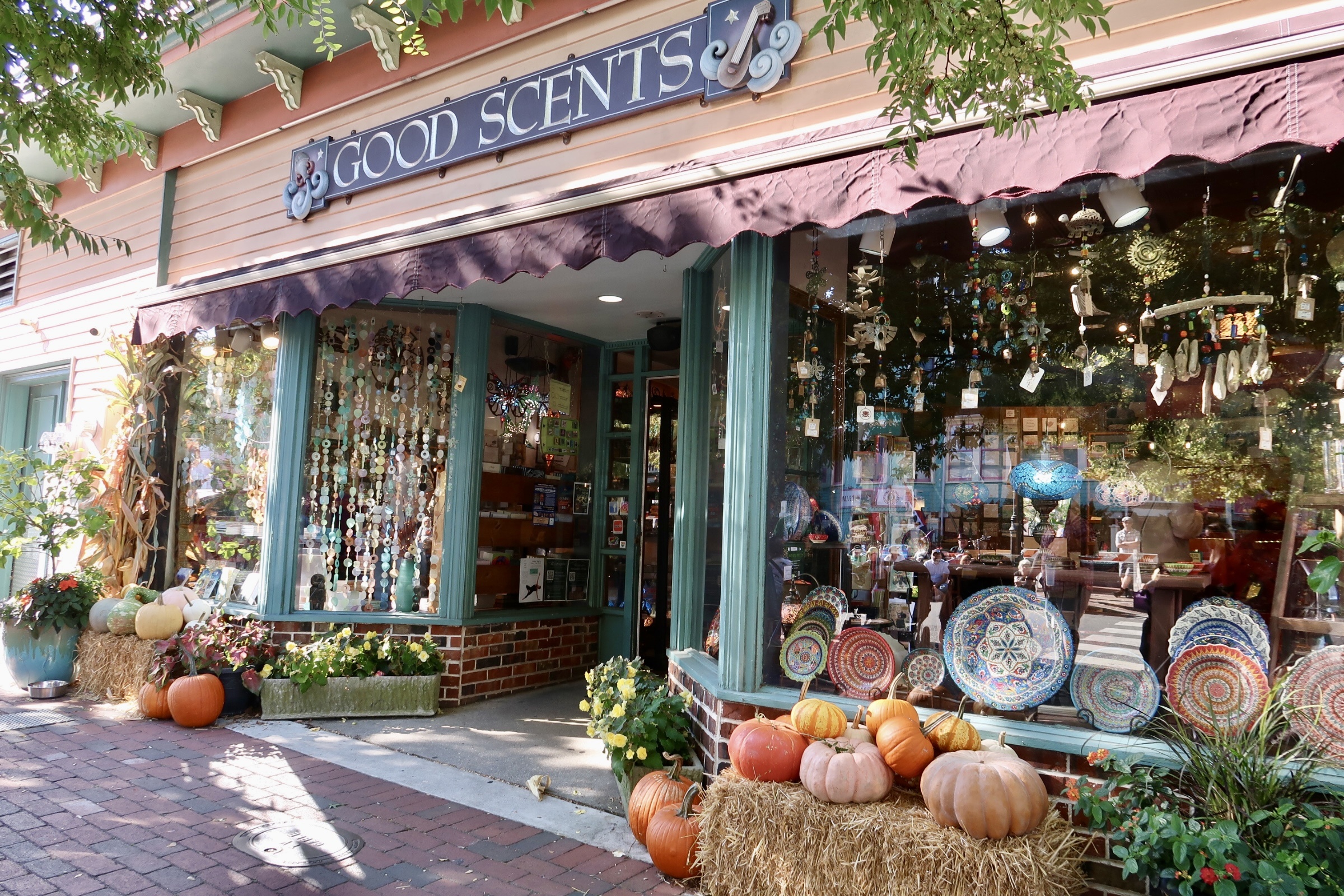 Pumpkins and hay out front of Good Scents